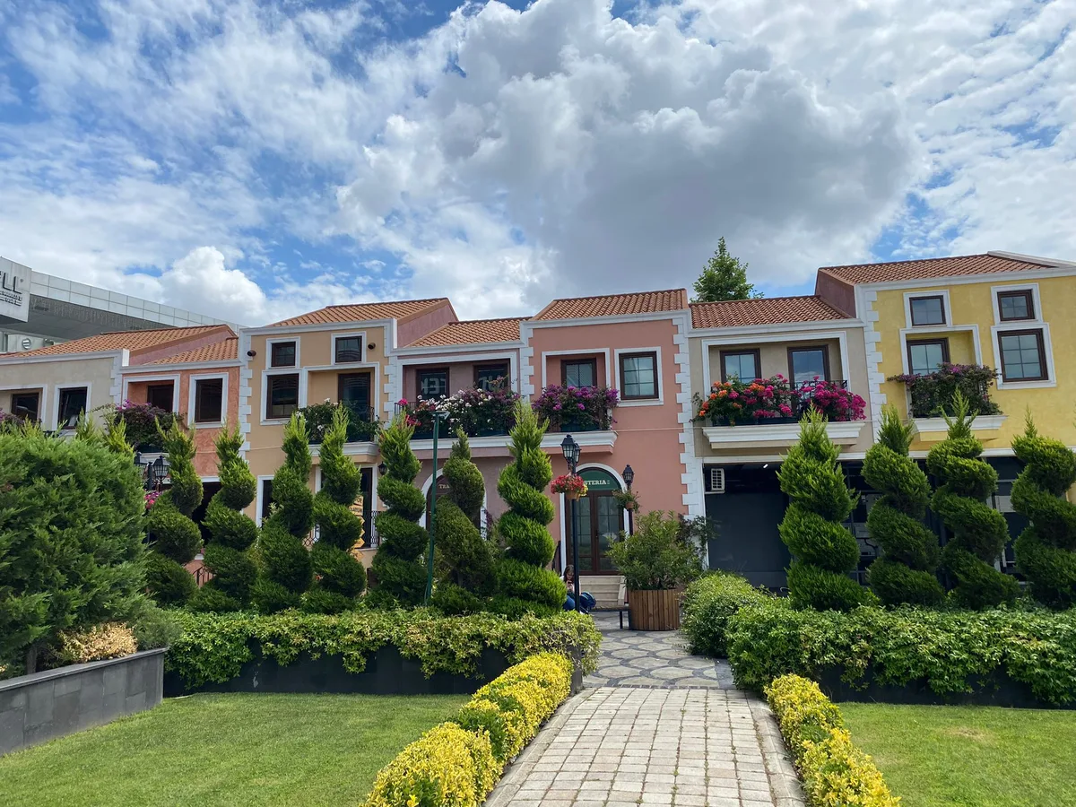 Dudullu İtalyan Evleri’nde balkon begonvilleri, renkli cepheler ve giriş yolunu çevreleyen dış alan bitkileri